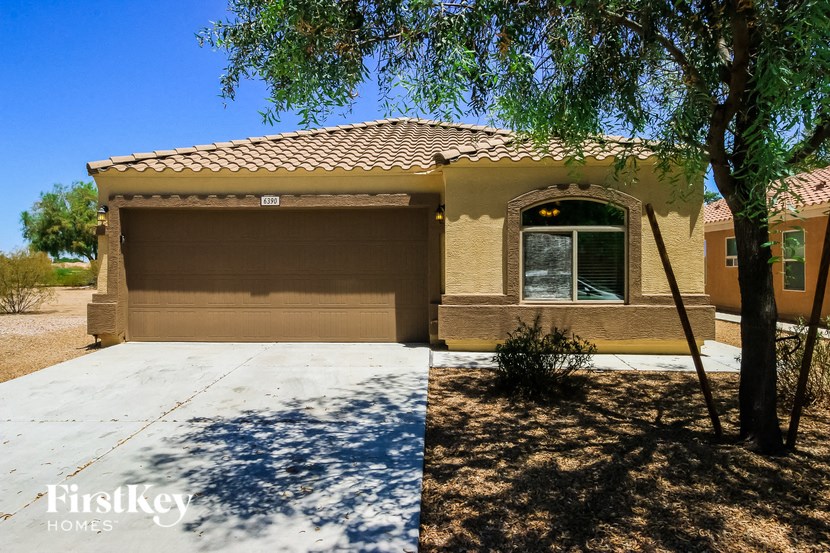 a house with a garage and a tree