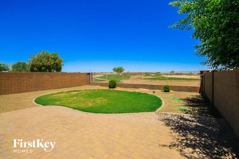 a circular lawn in the middle of a brick driveway