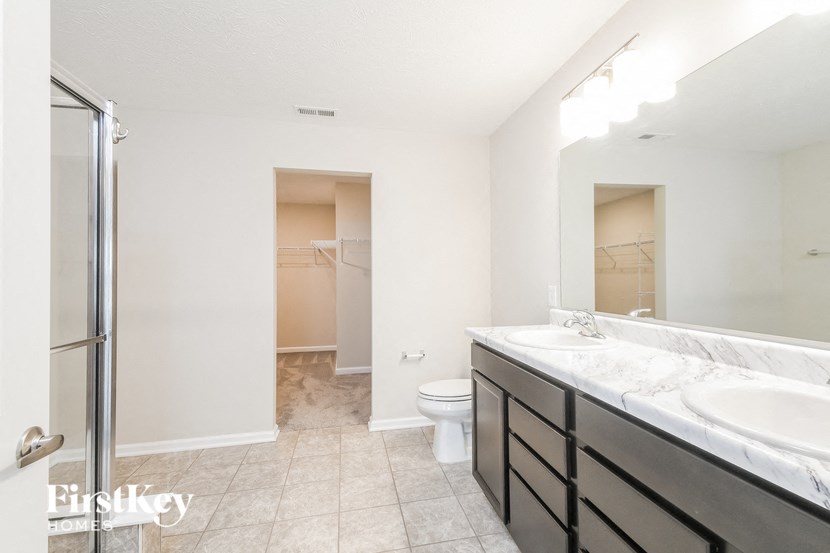 a bathroom with a sink and a shower and a toilet