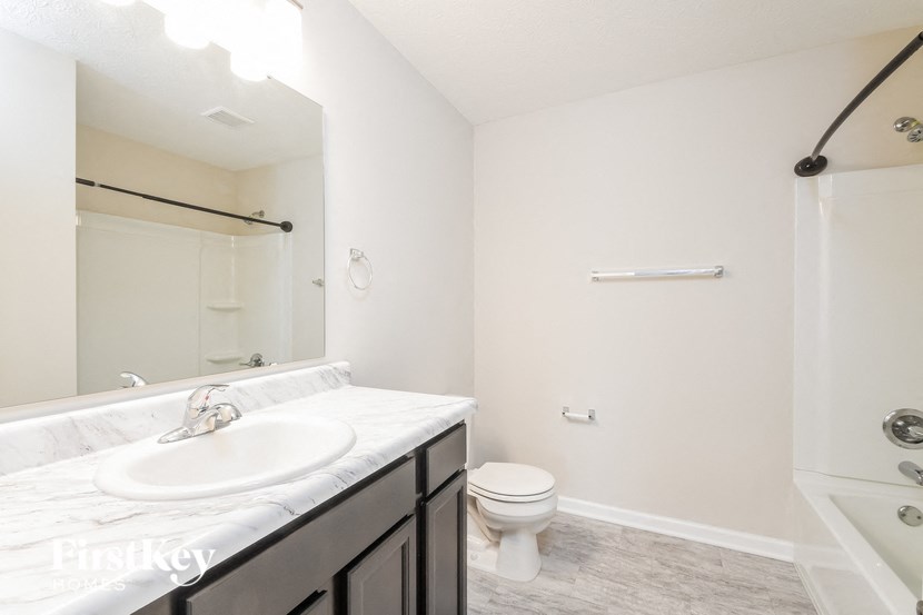 a bathroom with a sink and a toilet and a mirror