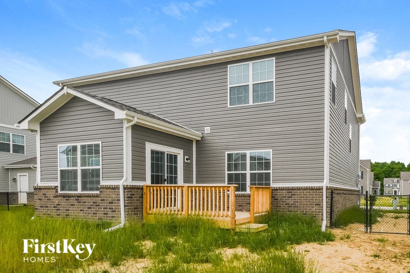 a home with a deck in front of a house