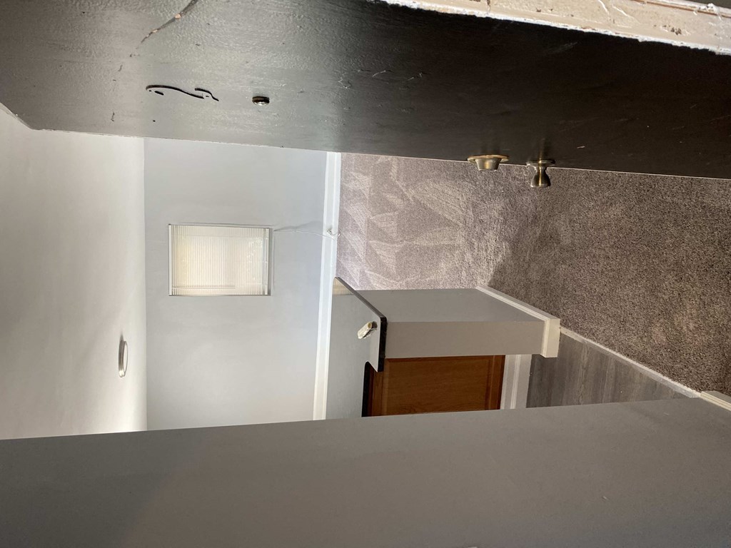 a view of the kitchen from the top of the stairs