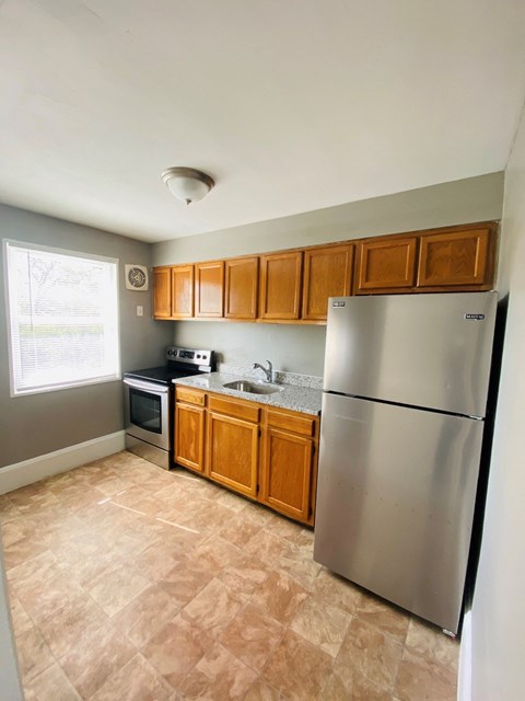 a kitchen with stainless steel appliances and wooden cabinets