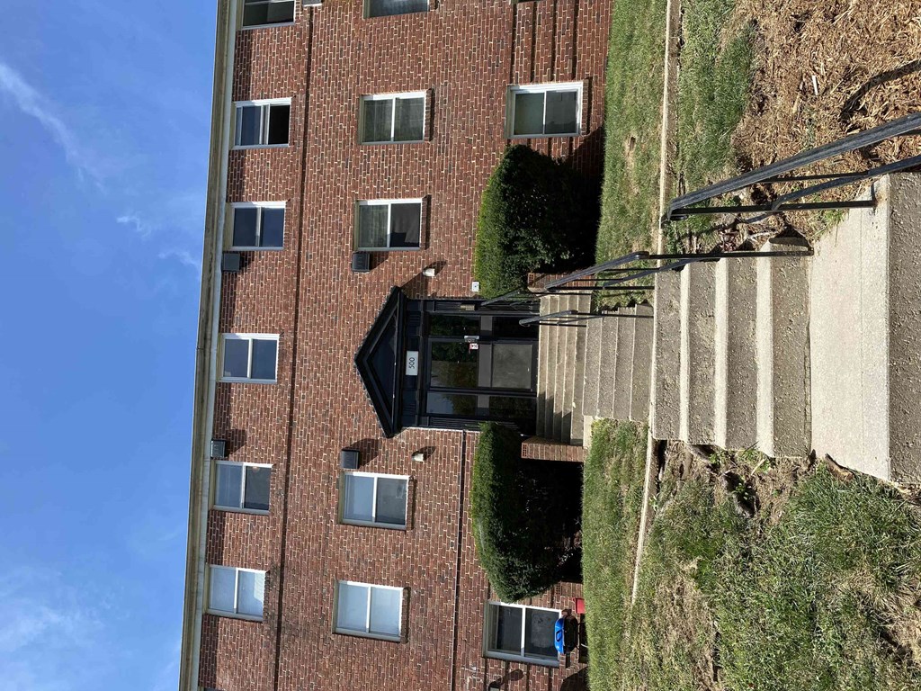 an aerial view of a tall brick building with windows