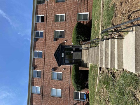 an aerial view of a tall brick building with windows