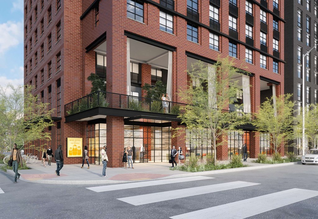 a rendering of a large brick building with people walking on the street