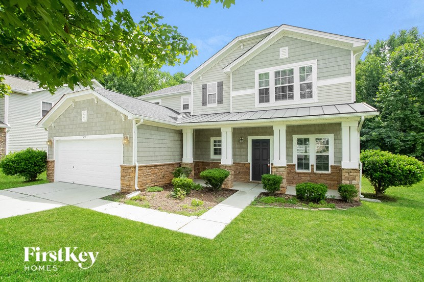 a white house with a yard and a white garage door