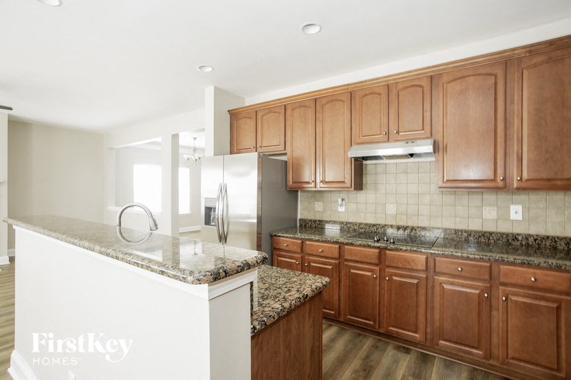 a kitchen with wooden cabinets and granite counter tops
