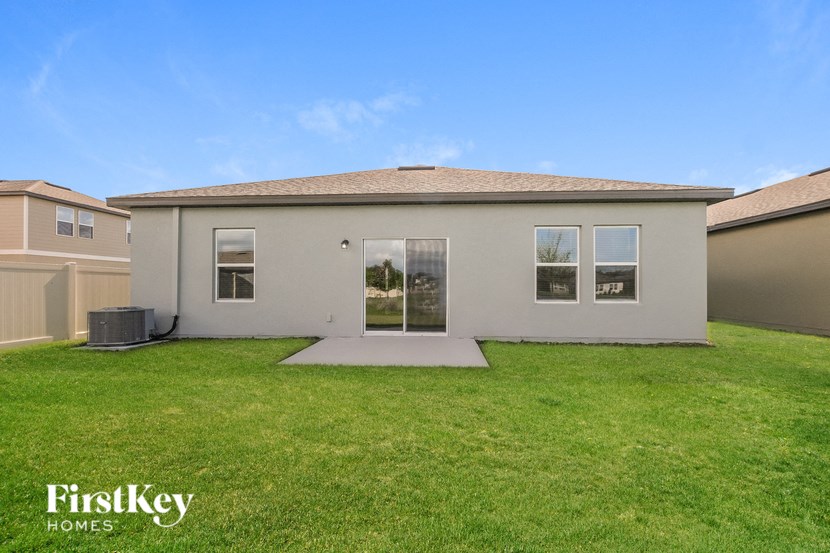 A house with a lawn in front of it is for sale by FirstKey Homes.
