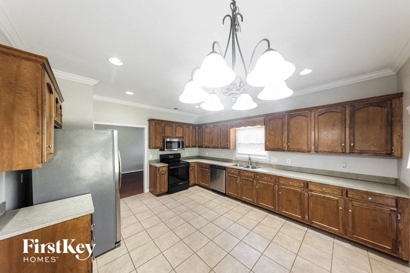 a kitchen with wooden cabinets and a stainless steel refrigerator
