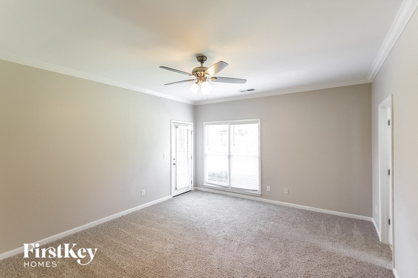 a living room with a ceiling fan and a window