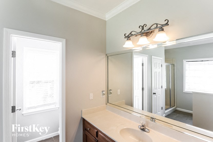 a bathroom with a large mirror and a sink
