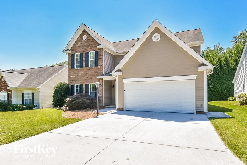 a beige house with a white garage door