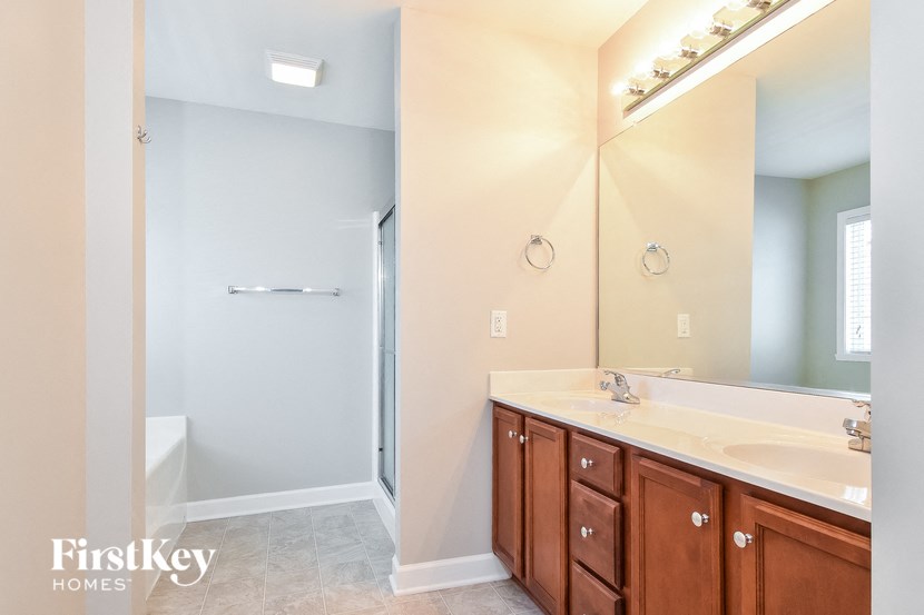 a bathroom with a large mirror and two sinks