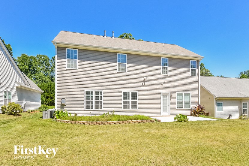 a white house with a yard in front of it