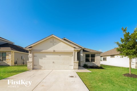 a house with a white garage door and a lawn