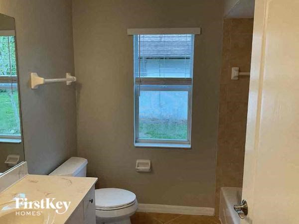 a small bathroom with a toilet and a window