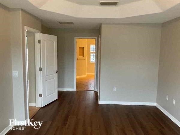 an empty empty living room with a wood floor