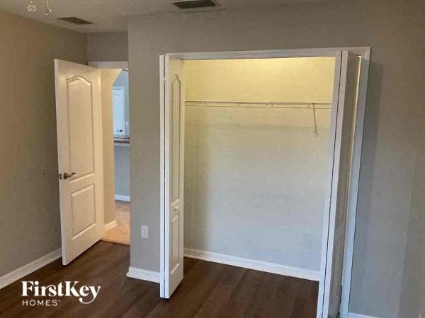an empty room with a closet and an open door