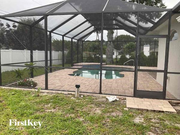 a patio with a pool in a glass house