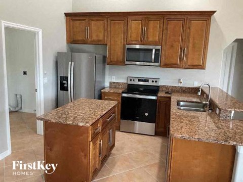 a kitchen with stainless steel appliances and granite counter tops