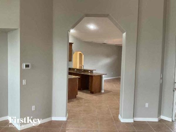a hallway with a dining room and a kitchen
