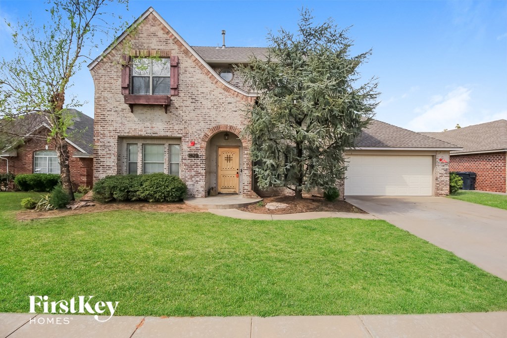 A brick house with a brown door and a garage.