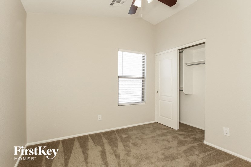 an empty room with a closet and a window