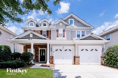 a white house with two white garage doors
