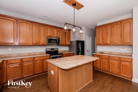 a kitchen with wooden cabinets and a large counter top