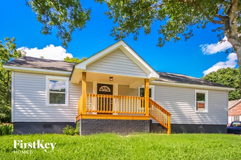 the front of a house with a yellow porch