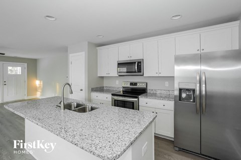 a kitchen with granite counter tops and stainless steel appliances