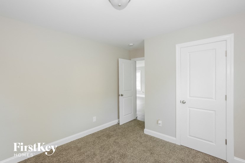 a bedroom with two closets and a door to a bathroom
