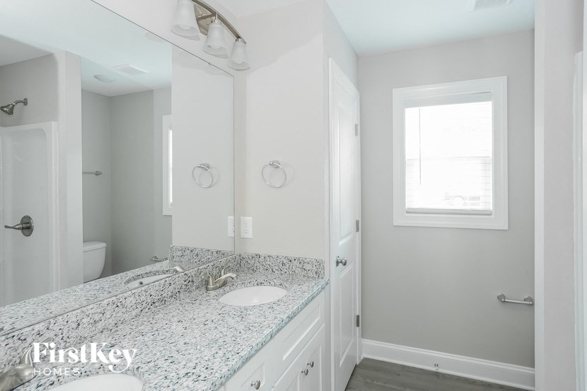 a white bathroom with a sink and a mirror
