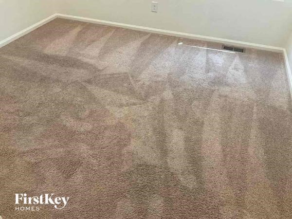a carpeted floor in a room with a heater