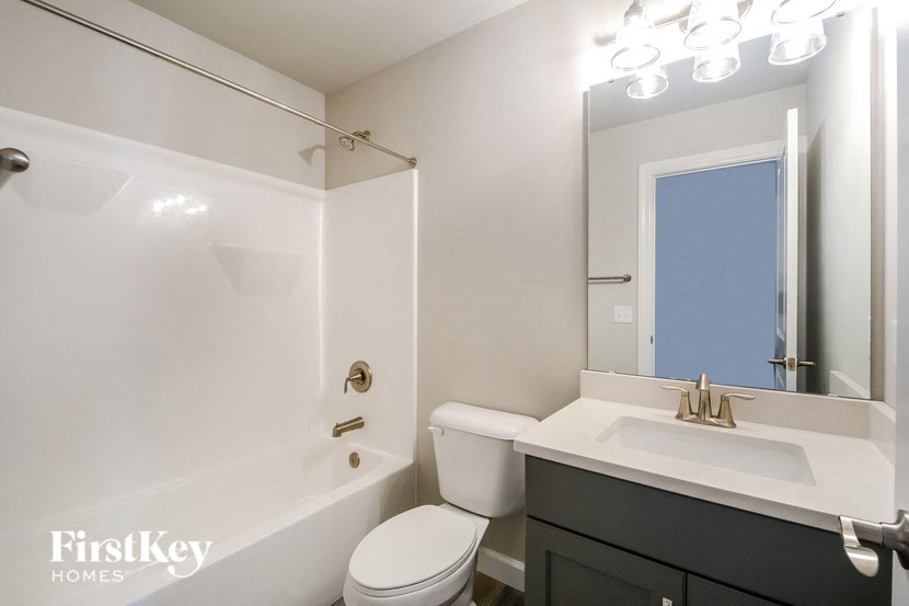 a bathroom with a sink toilet and a bath tub