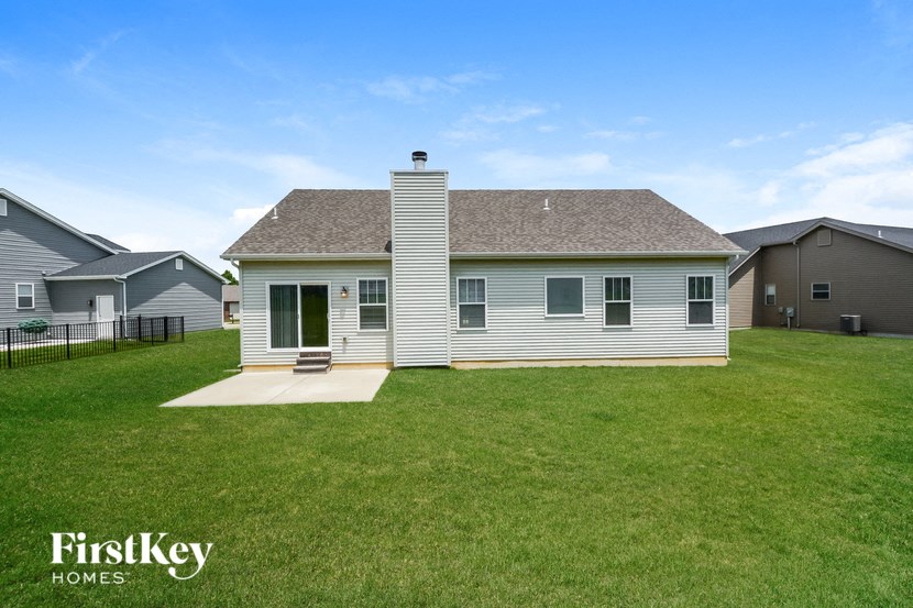 a white house with a yard in front of it