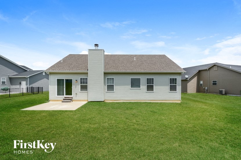front view of a white house with a grassy yard