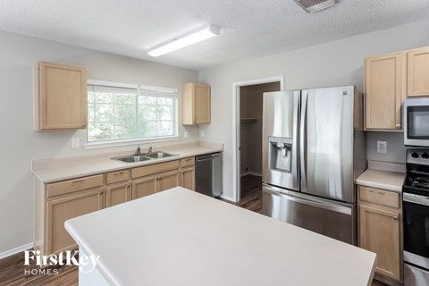 A kitchen with wooden cabinets and stainless steel appliances.