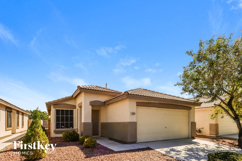 a house with a garage door and a tree