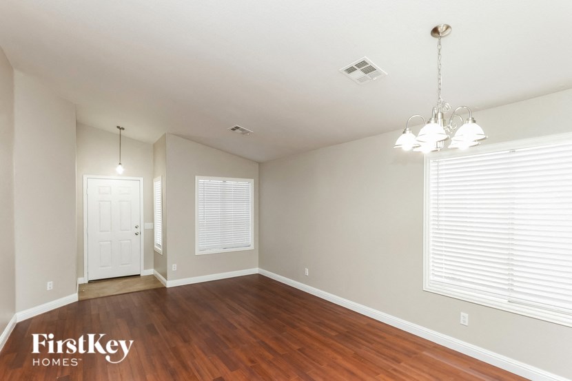 a living room with wood floors and a white door