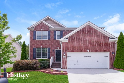 a red brick house with a white garage door