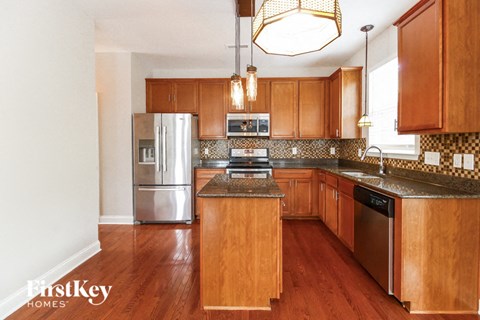 a kitchen with wooden cabinets and stainless steel appliances