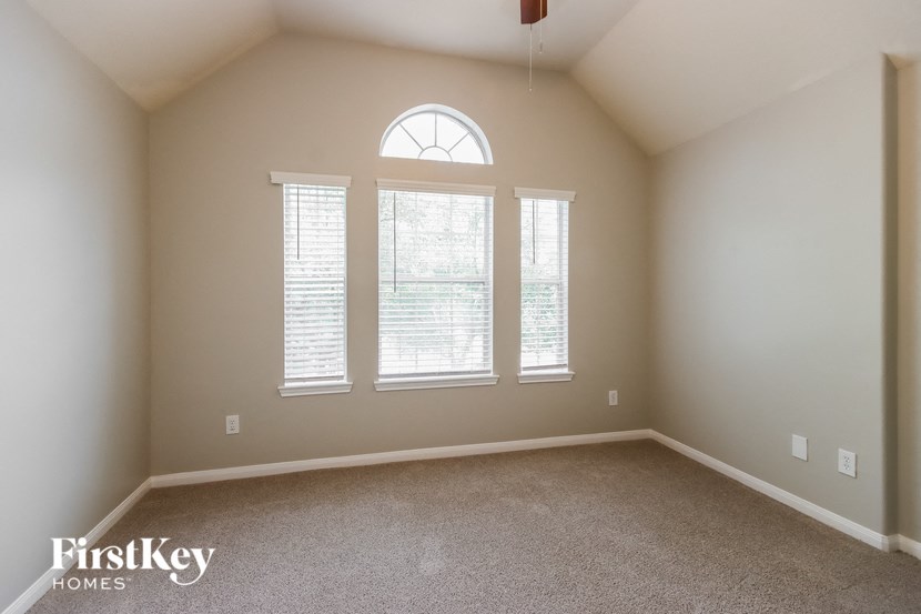 a large empty room with three windows