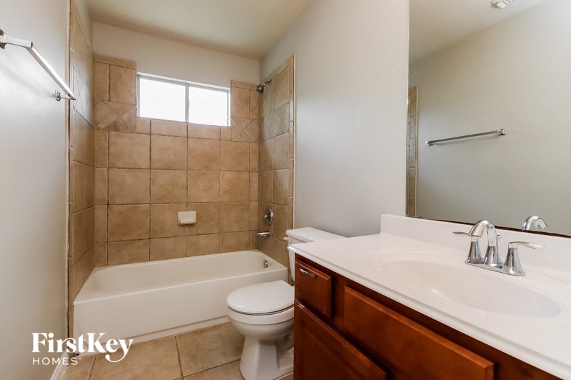 a bathroom with a sink toilet and a bath tub