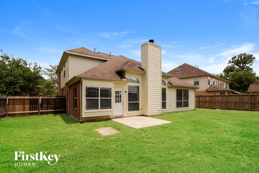 a backyard with a house and a yard with grass