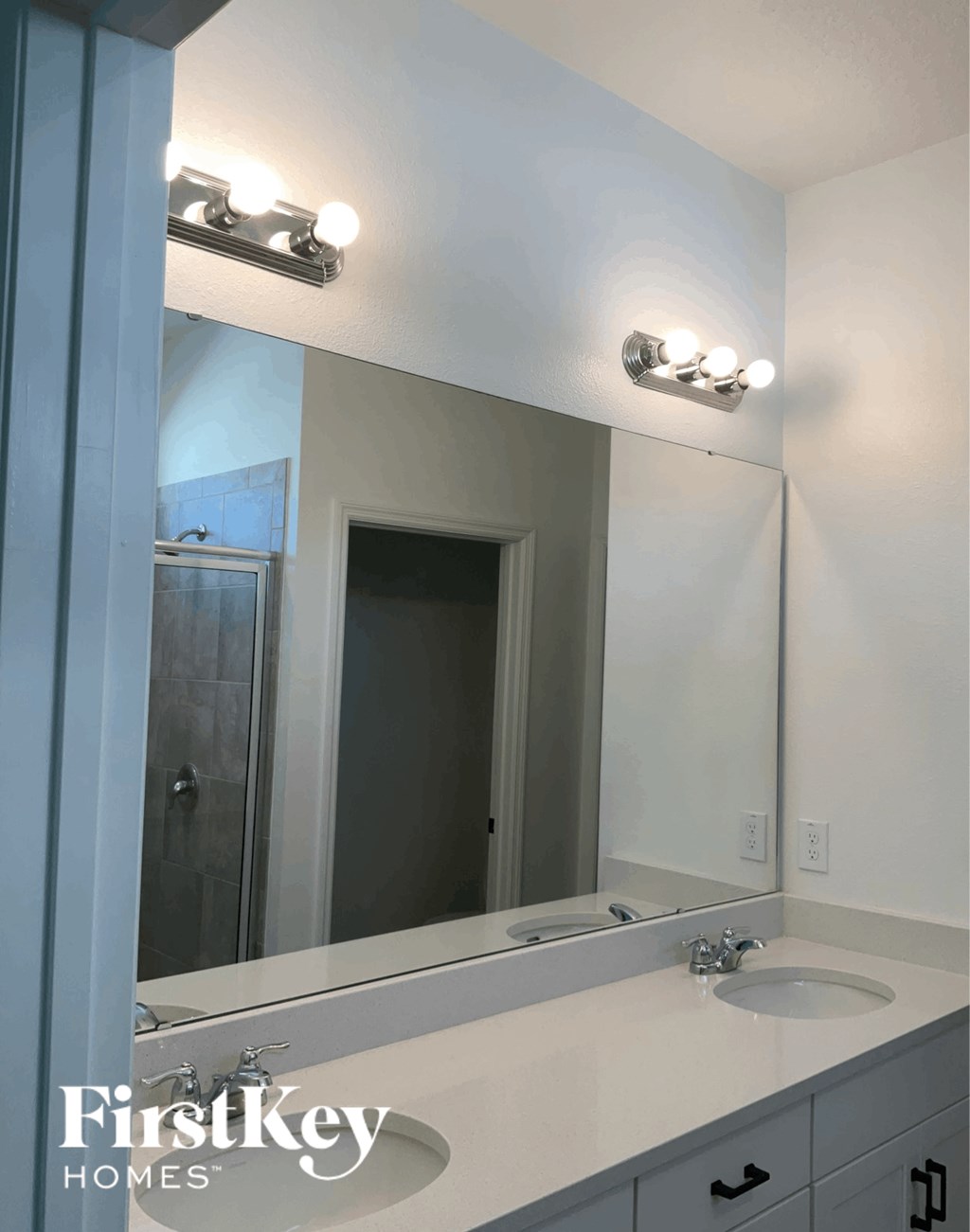 a bathroom with a mirror and a sink and a shower