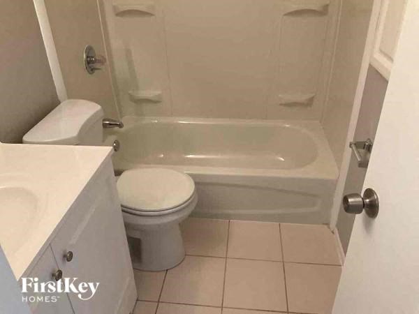 a bathroom with a toilet and a bath tub