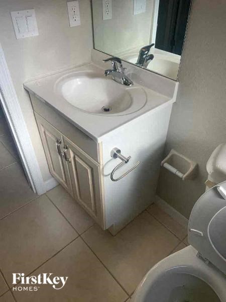 A white sink in a small bathroom cabinet.