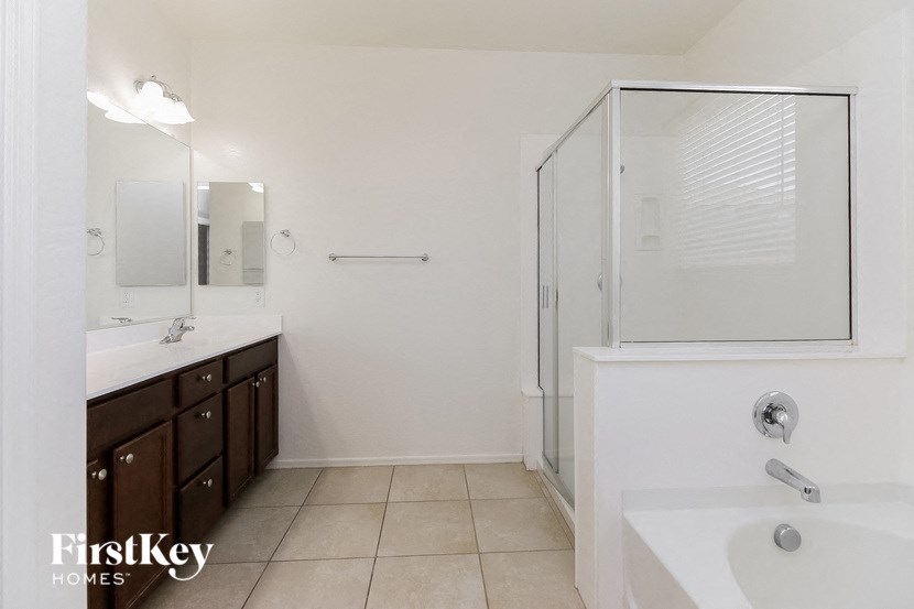 a white bathroom with a shower and a sink